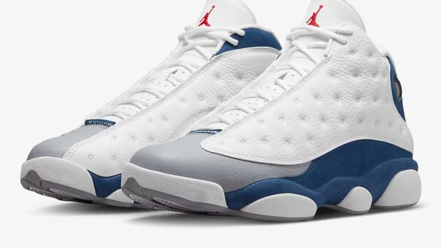White and blue Air Jordan 13 shoes.